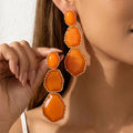 Boucles d’Oreilles Dorées en Résine Orange Géométrique